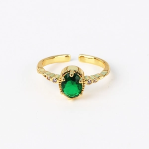 Detail of adjustable gold ring with emerald green stone and side micro-inlay crystals