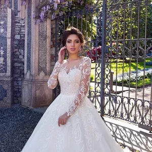 Elegant white long sleeve lace wedding dress with embroidery and a full trail skirt