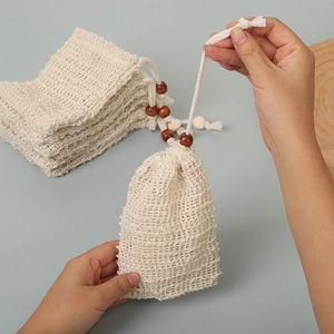 Detail of cotton linen soap bag showing natural mesh texture and wooden bead drawstring