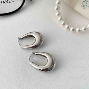 Polished silver teardrop earrings displayed with chic lifestyle fashion accessories