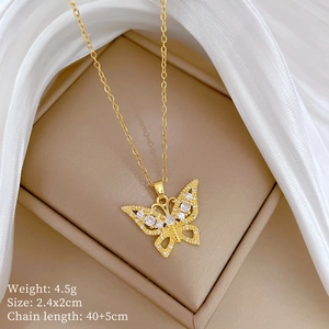 Macro shot of gold-plated butterfly pendant with sparkling cubic zirconia on white silk