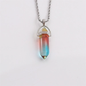 Macro shot of a hexagonal bullet-shaped crystal pendant with yellow, red and blue gradient