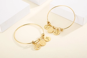 Detailed view of adjustable gold constellation bracelets with Scorpio and Cancer charms