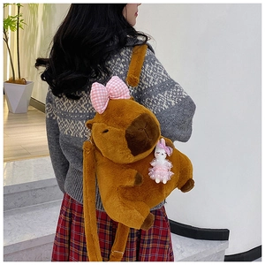Brown plush Capybara backpack with pink checkered bow and cute rabbit charm detail