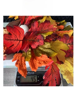 Detailed view of autumn maple leaf wreath decoration weighing approximately 45g on a scale