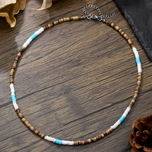 Bohemian necklace with coconut shell wood beads and turquoise accents on dark wood