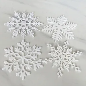 Set of 4 white plastic snowflake ornaments in various patterns for Christmas decor