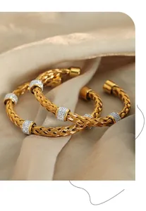 Detail of woven gold-plated titanium steel bangle sets with sparkling zircon insets