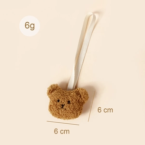 Gros plan détaillé d'une attache-tétine ours en peluche avec dimensions 6cm et poids de 6g