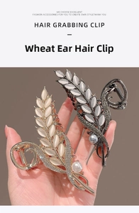 Detail of wheat ear hair claws featuring cat eye stones, pearls, and rhinestones