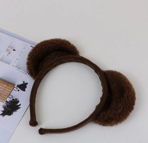 Detailed view of dark brown plush monkey ear headband with soft faux fur texture