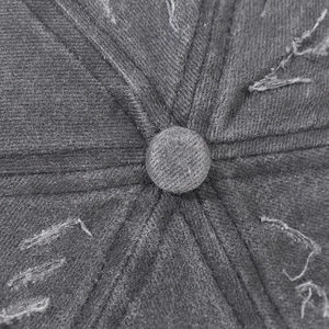 Detailed top view of a distressed dark grey baseball cap showing frayed cotton fabric