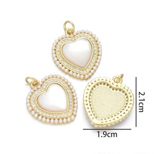 Detail view of heart pendants with shell inlay and pearls showing 2.1cm size dimensions
