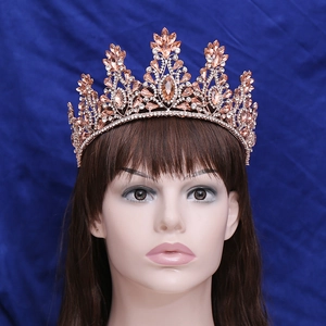 Detailed macro view of champagne crystal crown with rose gold bridal hair accessory base