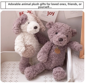 Close-up of plush bear and spotted dog dolls in a decorative tray as cozy gift ideas