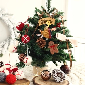 Miniature wooden Christmas tree with felt balls, pine cones and gingerbread ornaments