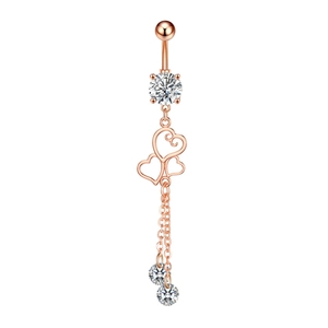 Macro shot of rose gold belly button ring with double chain and sparkling heart charms