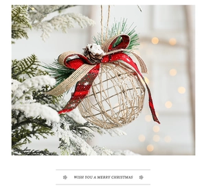 Close-up of rustic Christmas ball with plaid bow, natural pine cone and pine needles