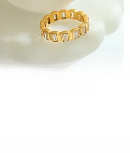 Detailed macro view of the gold eternity ring with rectangular zircons on a white plate