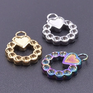 Detailed view of round heart charms in gold, silver, and rainbow stainless steel