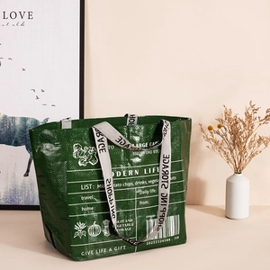 Large green woven shopping bag with white modern prints and portable handles for travel