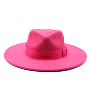 Detailed view of hot pink wide-brim wool fedora hat with matching satin ribbon trim