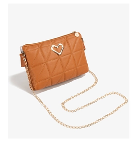 Detail of brown quilted PU leather crossbody bag with gold heart hardware and chain strap