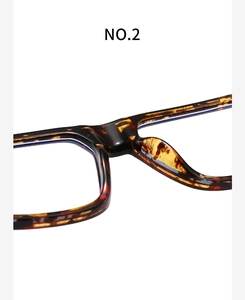 Macro view of tortoiseshell acetate frame bridge and integrated nose pads for eyewear