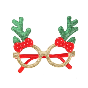 Detail of Christmas glasses frame with gold rims, green antlers, and red bow