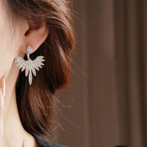 Silver leaf floral pendant earrings with zircon stones and wing-shaped luxury design