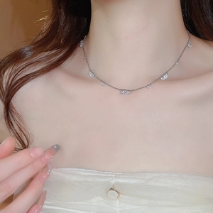 Elegant silver stainless steel necklace with sparkling crystals worn by a female model