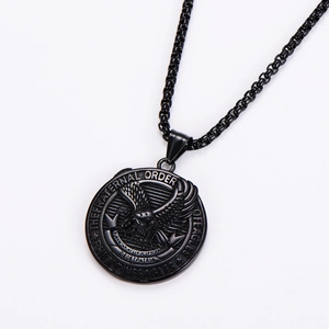 Close-up of black metal eagle crest pendant with Liberty Truth Justice Equality engraving