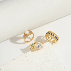 Retro gothic gold open rings set with blue gemstones, pearls, and starfish motif