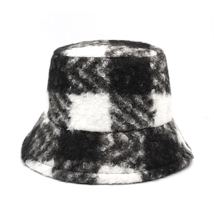 Detailed view of the thick black and white checkered plush fabric on a winter bucket hat