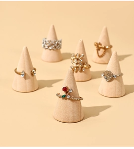 Macro shot of 6-piece fashion ring set displayed on elegant wooden cone stands