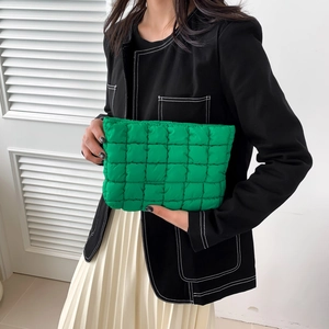 Fashionable green pleated makeup clutch bag featuring a square quilted pattern and padding