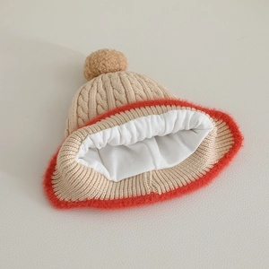Knitted baby winter hat with cable pattern, faux fur trim and fluffy pom pom detail