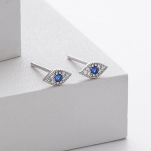 Close-up of S925 sterling silver evil eye stud earrings with blue stones and crystals