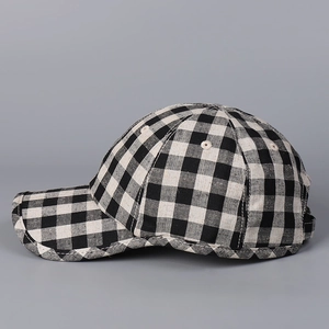 Detail shot of black and white plaid linen baseball cap featuring a six-panel crown