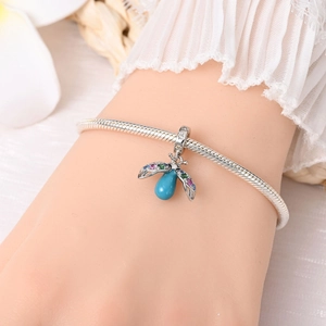 Detailed view of silver charm bracelet with glowing firefly pendant and colorful stones
