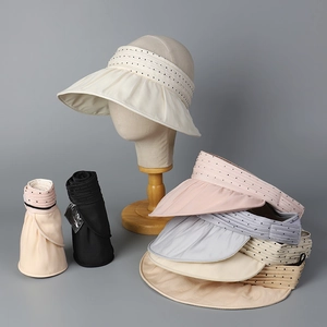 Detail view of foldable organza sun hats in various colors with polka dot texture band