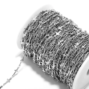 Detailed macro view of 5mm silver stainless steel cross chain on roll for DIY jewelry