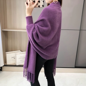 Detail of the elegant dark purple knitted shawl with fringe tassels and soft mink-like texture