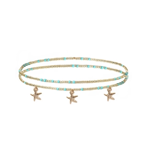 Détail de la chaîne de taille perlée à double rangée avec étoiles de mer dorées et perles