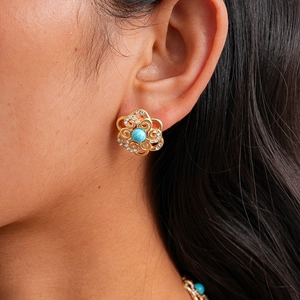 Close-up of bohemian floral earring with blue stone and sparkling crystal accents