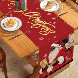 Festive Christmas table runner featuring Santa and gold Merry Christmas text on red fabric