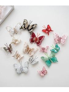 Detailed macro view of embroidered feather butterflies with lace and sequins