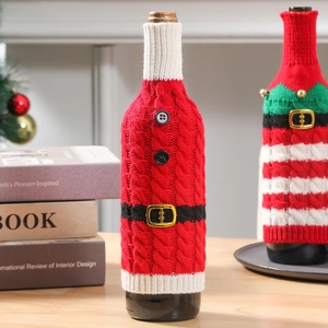 Detailed view of striped knit wine bottle covers with Santa belt and elf bell ornaments