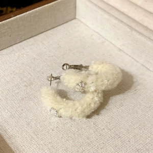 Chic silver needle flocked cream hoop earrings with silver snowflake accents for winter