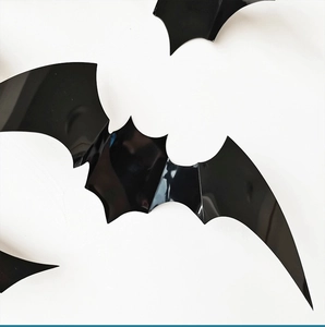 Detail showing 3D black PVC bat wall stickers with wings folded for Halloween decor